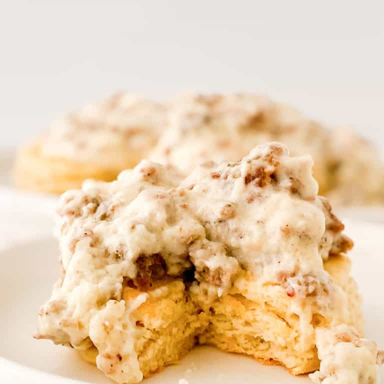 Homemade biscuit covered in sausage gravy.