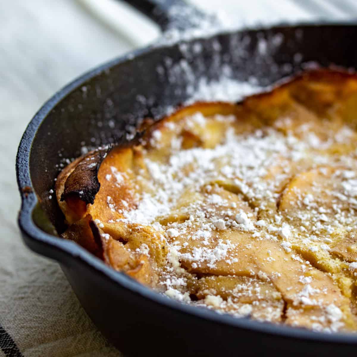 apple pancake in cast iron skillet.