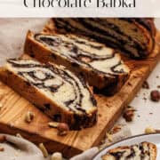 Chocolate babka sliced on wood cutting board.