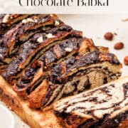 Chocolate babka sliced on wood cutting board.