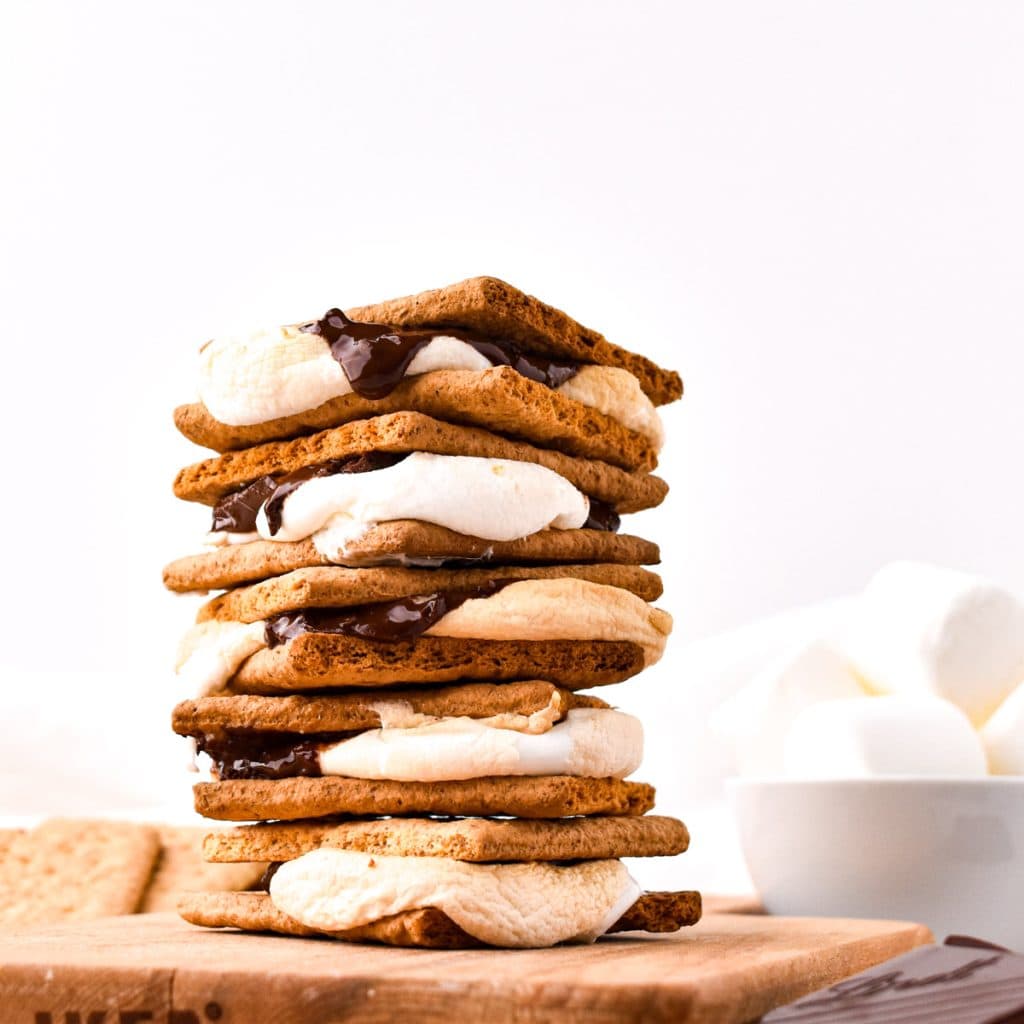 Stack of S'mores on wooden board.