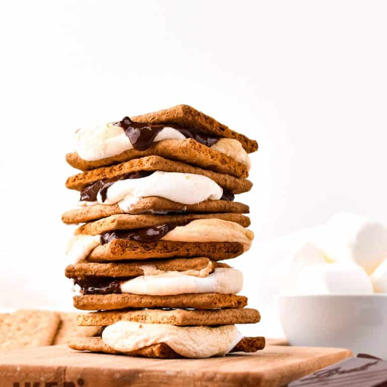 Stack of S'mores on wooden board.