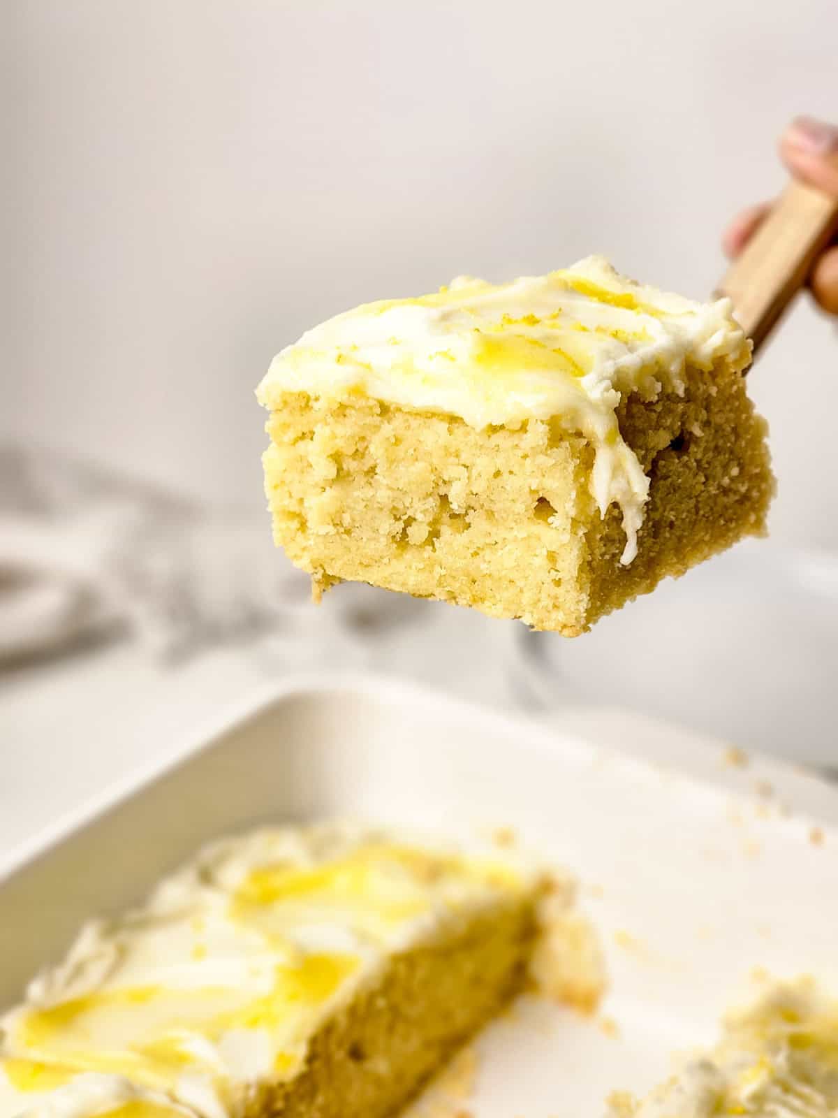 Slice of lemon cake on a cake server.