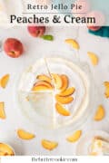 A pie topped with whipped cream and sliced peaches sits on a marble surface, surrounded by fresh peaches and peach slices. One slice is served on a plate, and Peaches & Cream is written at the top.