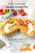 A glass pie dish holds an old-fashioned maple syrup pie topped with whipped cream and sliced strawberries. A slice is missing, and fresh strawberries and a glass of milk are in the background. Text reads Old-Fashioned Maple Syrup Pie.
