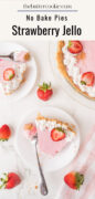 A no-bake strawberry Jello pie topped with whipped cream and fresh strawberries is served on white plates with a fork. Whole strawberries are scattered nearby. The scene is bright and inviting.