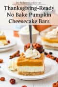 A fork is stuck into a pumpkin cheesecake bar with a graham cracker crust, topped with whipped cream, on a white plate. More bars, whipped cream, and autumn decorations are in the background. Text at the top reads: “Thanksgiving-Ready No Bake Pumpkin Cheesecake Bars.”.